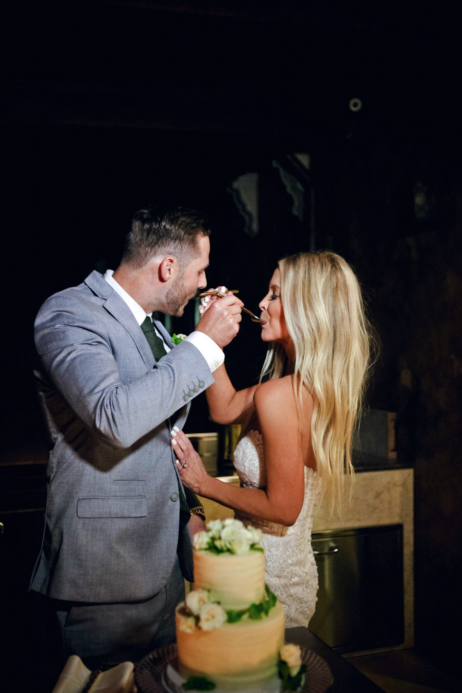 couple eating wedding cake